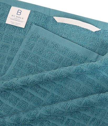 Bumble Towels hanging loop highlights easy air-drying and tidy storage.
