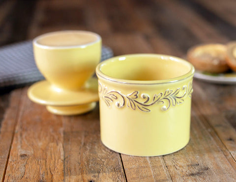Lid filling butter to create an airtight seal for freshness.