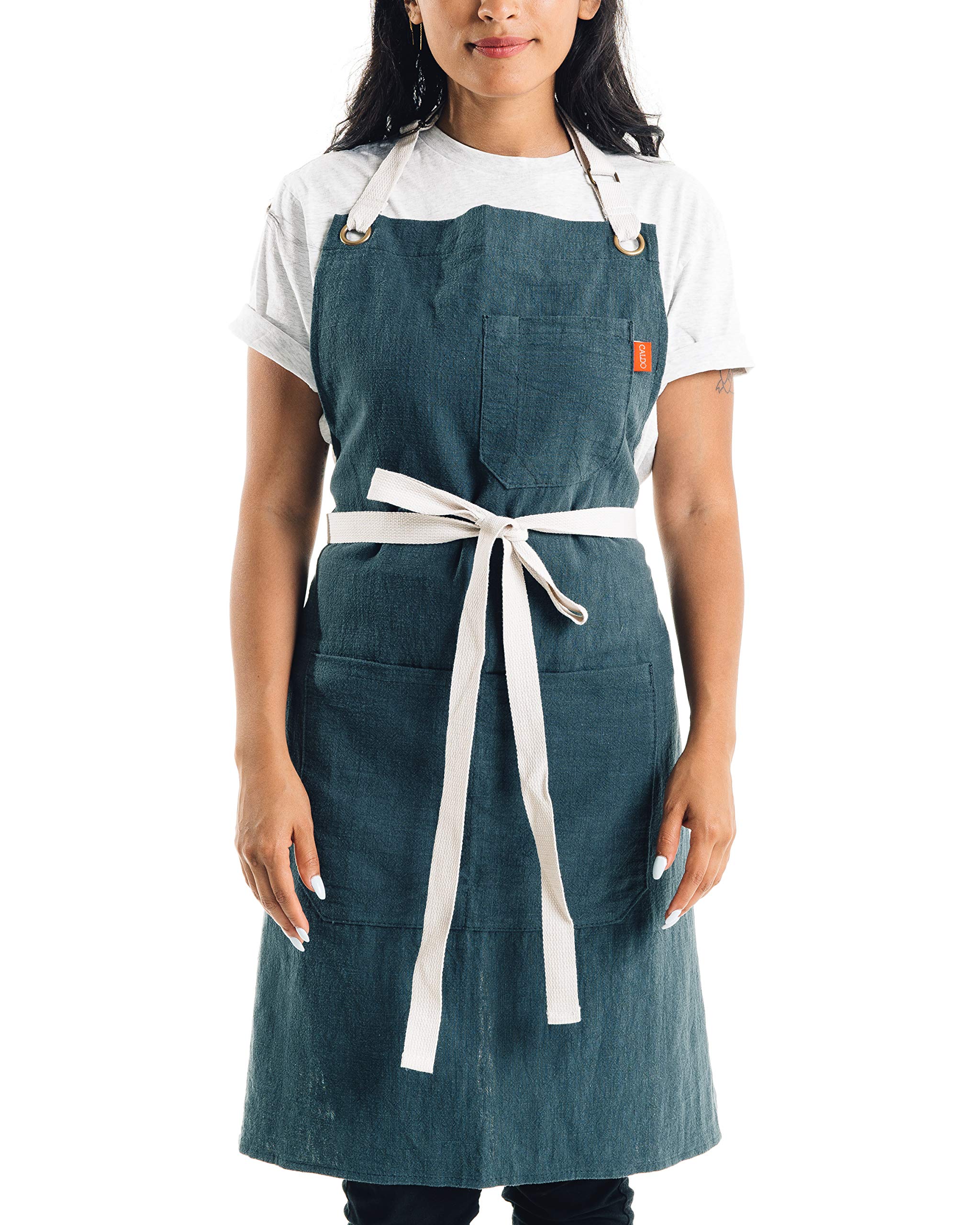 Caldo Linen Kitchen Apron front view in Spruce color with practical pockets for hands-on cooking.