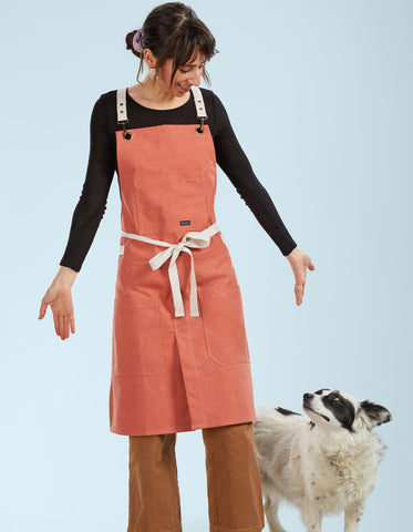 Caldo split-leg apron catches grease during cooking and pottery tasks