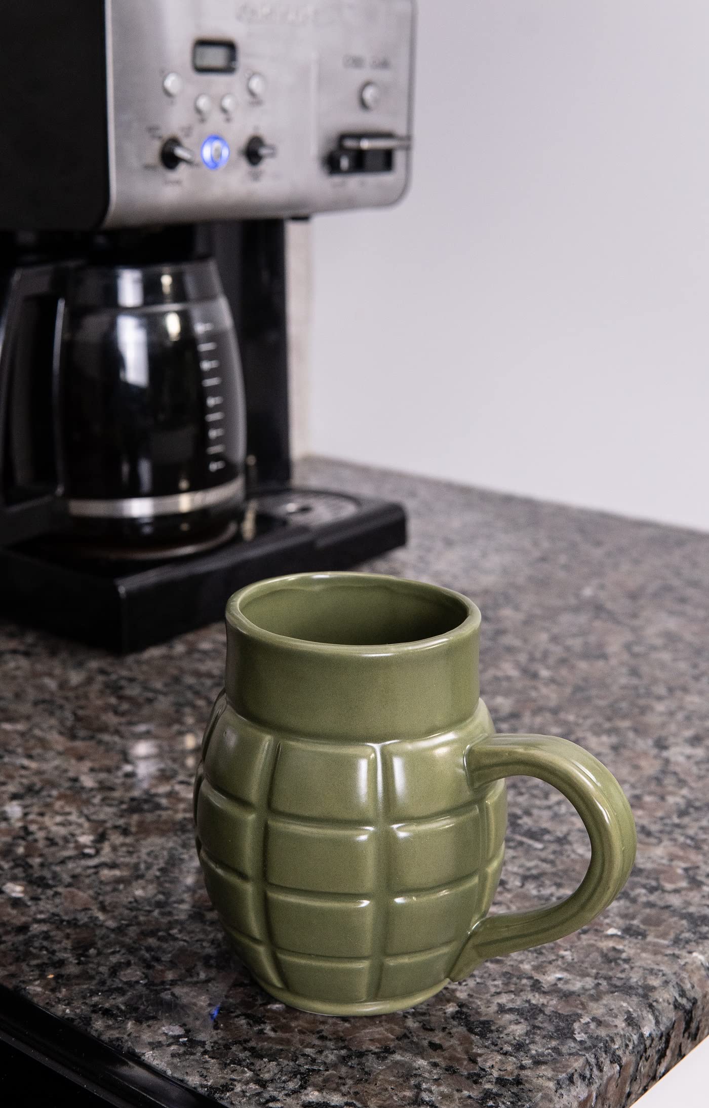 Caliber Gourmet Green Grenade Mug in use with coffee demonstrates unique appeal.
