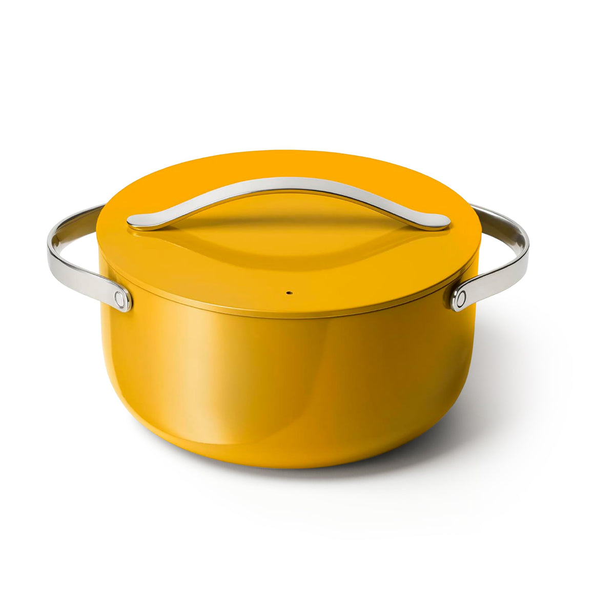 Caraway Dutch Oven 6.5 qt marigold lid on stove, ideal for slow roasts and simmered sauces.