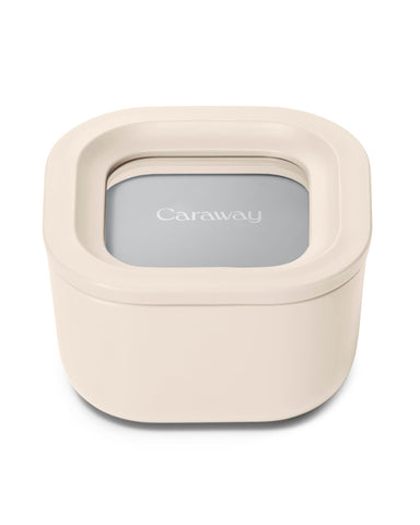 Caraway mini square container with lid in cream color, closed for freshness.