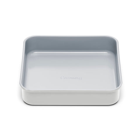 Caraway 9-inch square pan releasing fudgy brownies with the ceramic non-stick coating.