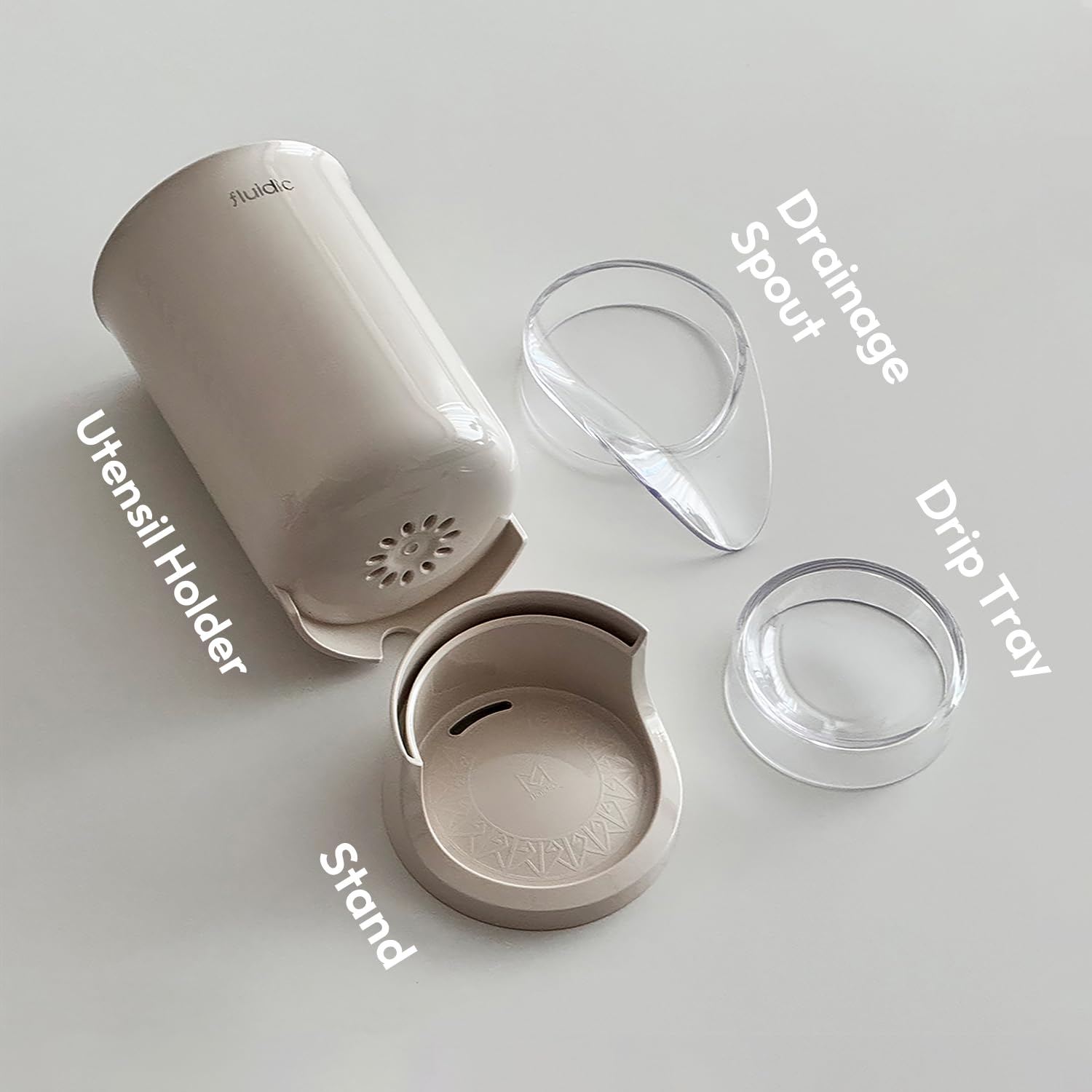 Carrotez beige utensil holder on kitchen counter for compact drying.