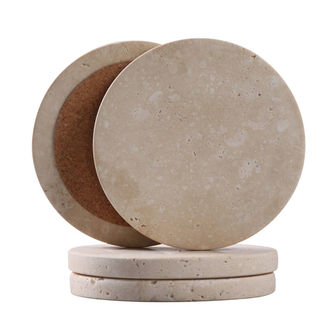 Casacouture travertine coaster close-up showing natural texture and heat protection.