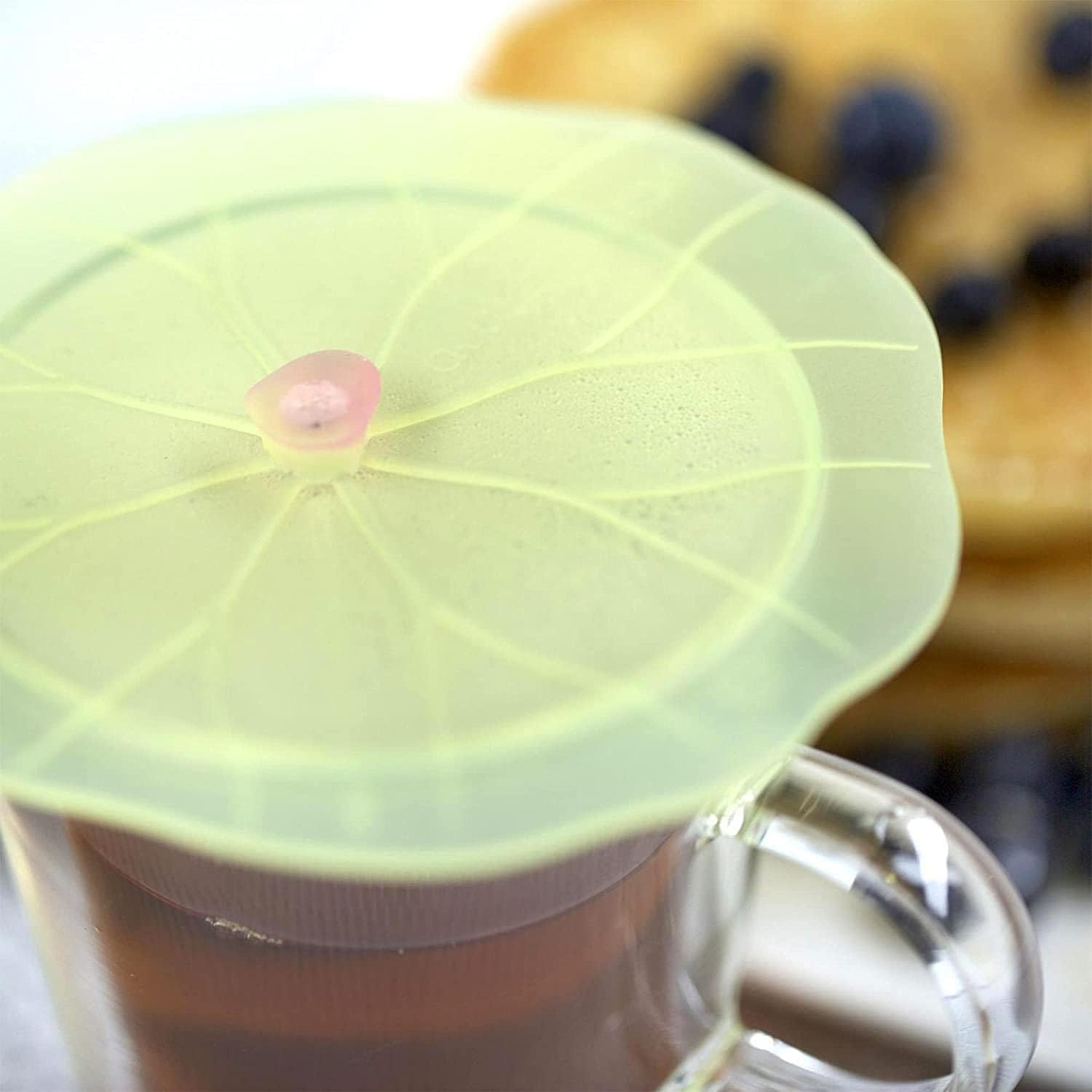 Lilypad cover on hot coffee helps retain heat and aroma.