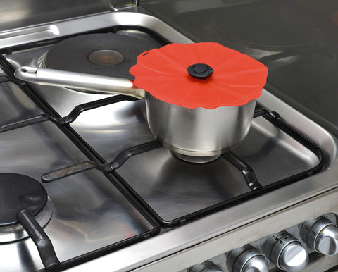 Charles Viancin Poppy lid placed on a pot for stovetop safety.