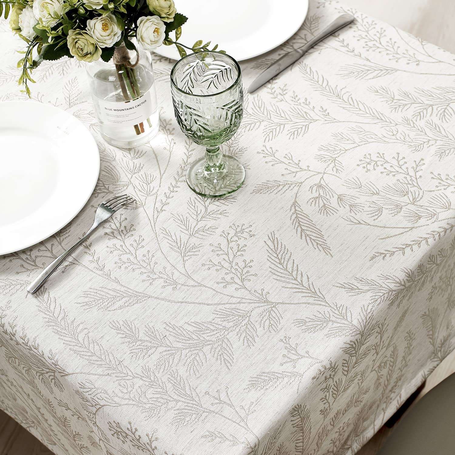 Chassic cream damask tablecloth enhances the dining room ambiance.
