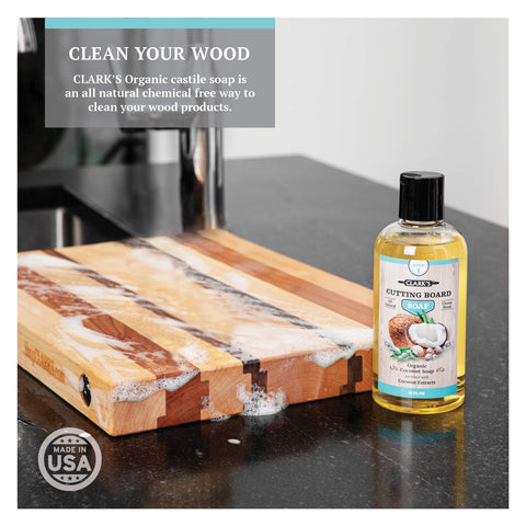 CLARK'S Scrub Brush cleans a wooden cutting board before conditioning.