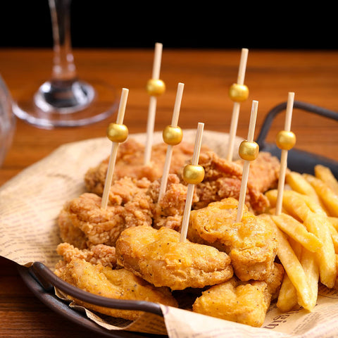 CockStixs wedding party toothpicks add a classy gold touch to reception plating.