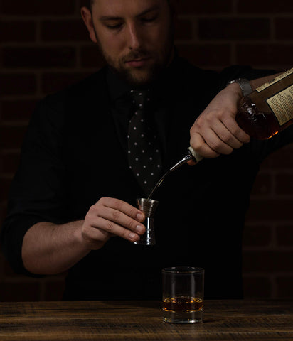 Cocktail Farmer US Standard Jigger in hand showing ergonomic design