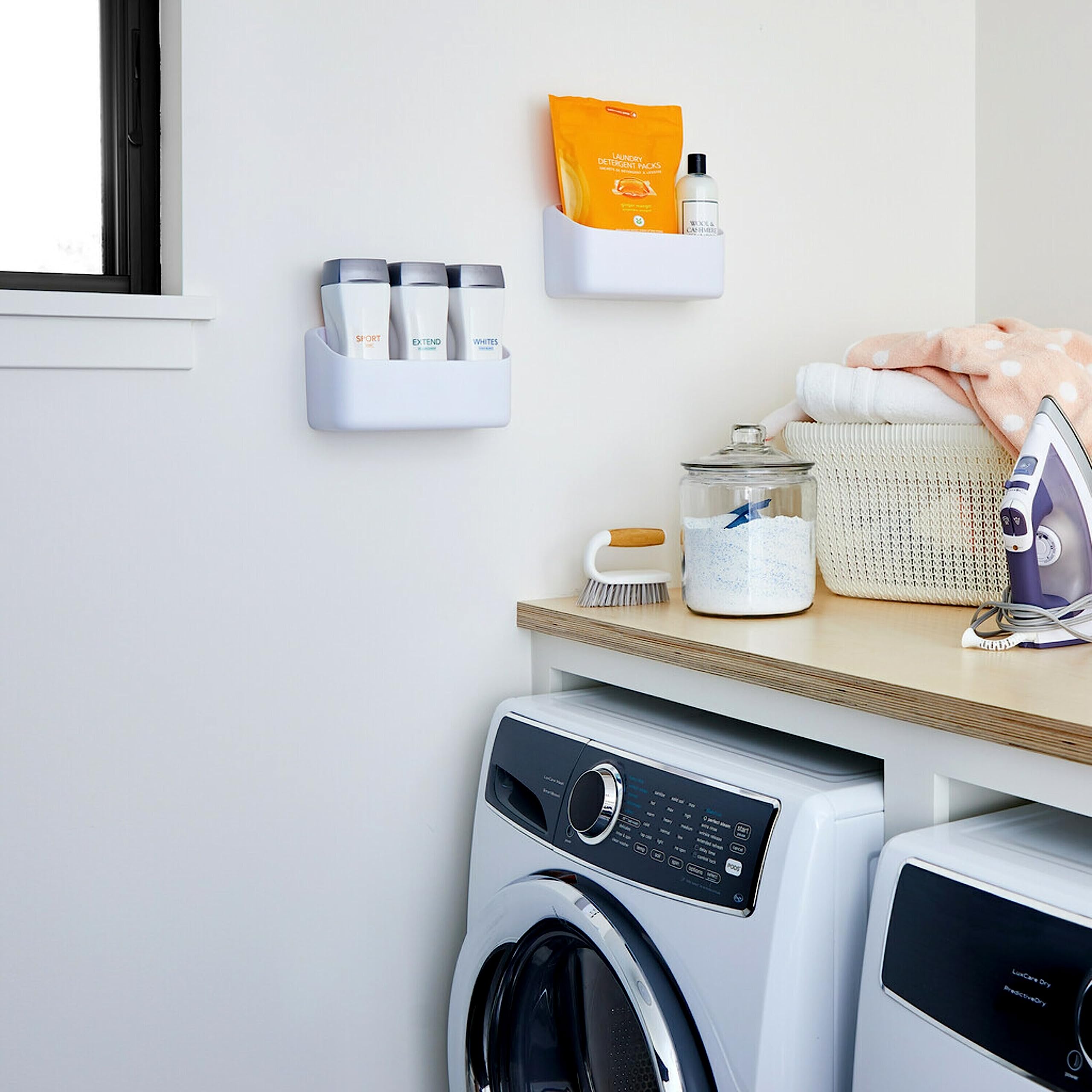 Pantry scene with Command Caddy organizing bottles and cleaners neatly.