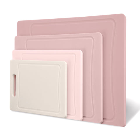 COOK WITH COLOR pink cutting boards hung for easy storage after use.