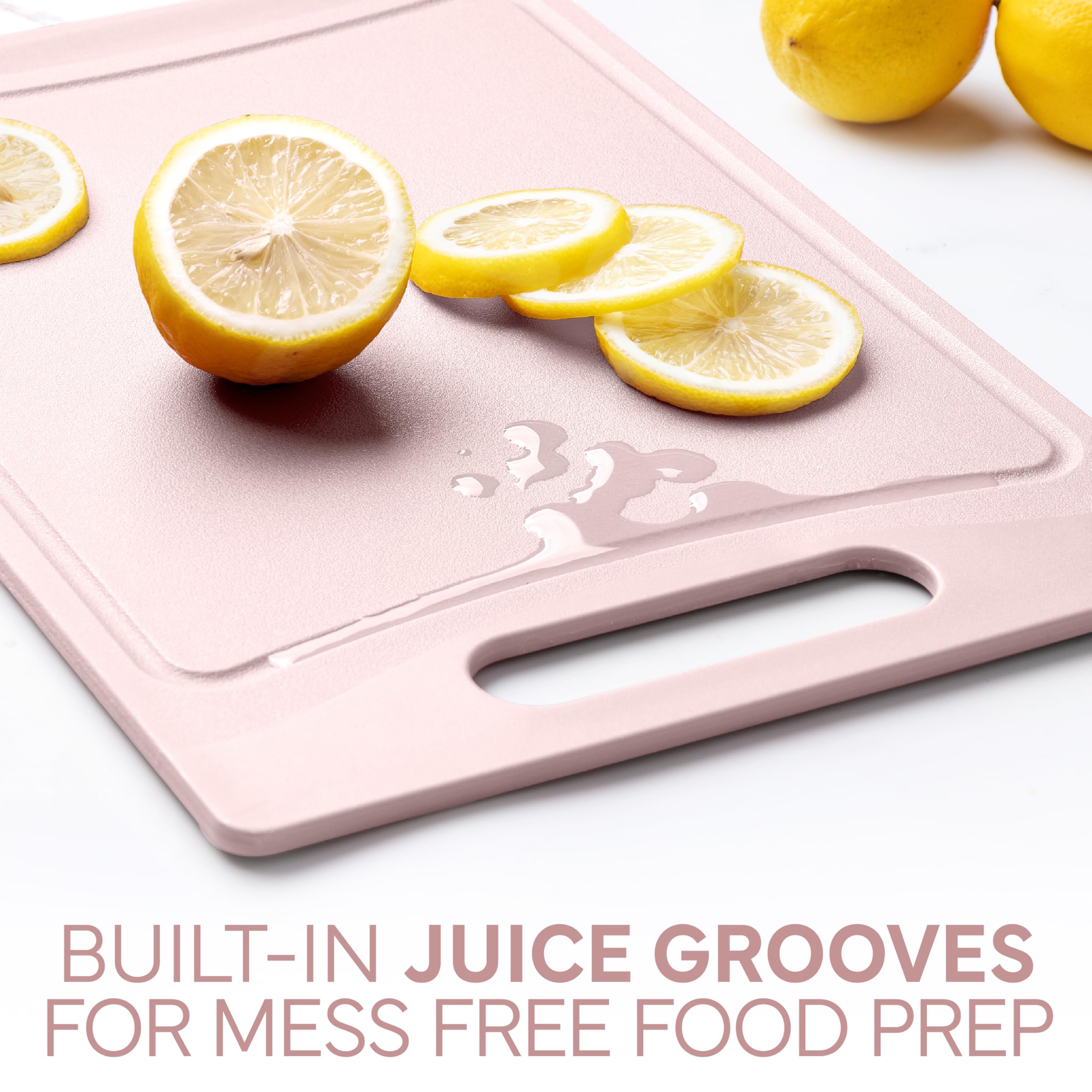 COOK WITH COLOR pink board with rubber feet prevents sliding while chopping.