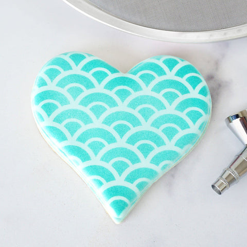 The Cookie Countess Magic Stencil Screen displays its eight-and-a-half-inch diameter for most stencils.