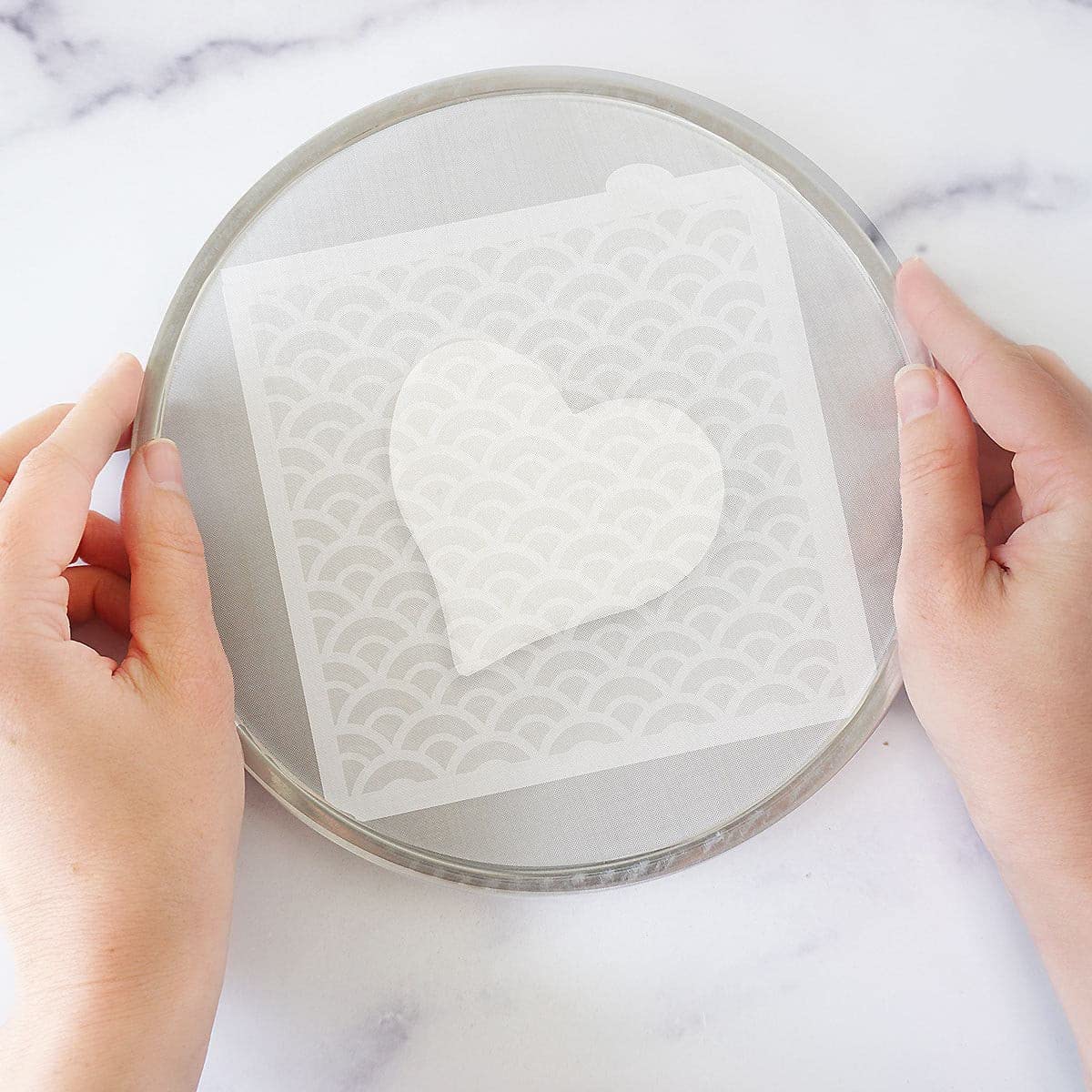 The Cookie Countess Magic Stencil Screen in use on a stencil supports even application.