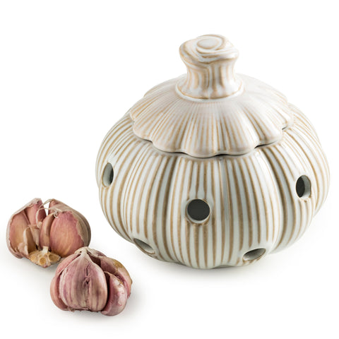 Cormomu ceramic garlic keeper with lid on kitchen counter adds whimsical decor while storing bulbs.