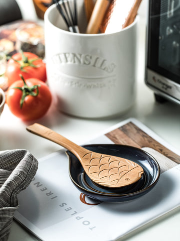 Cormomu spoon holder complements farmhouse kitchen style in gray and blue.