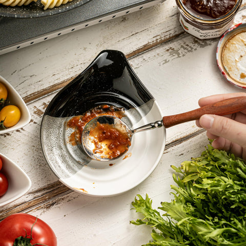 Cormomu spoon rest placed on stove top for convenient utensil placement