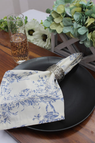 COTTON CRAFT navy toile napkins folded neatly, highlighting durable mitered corners.