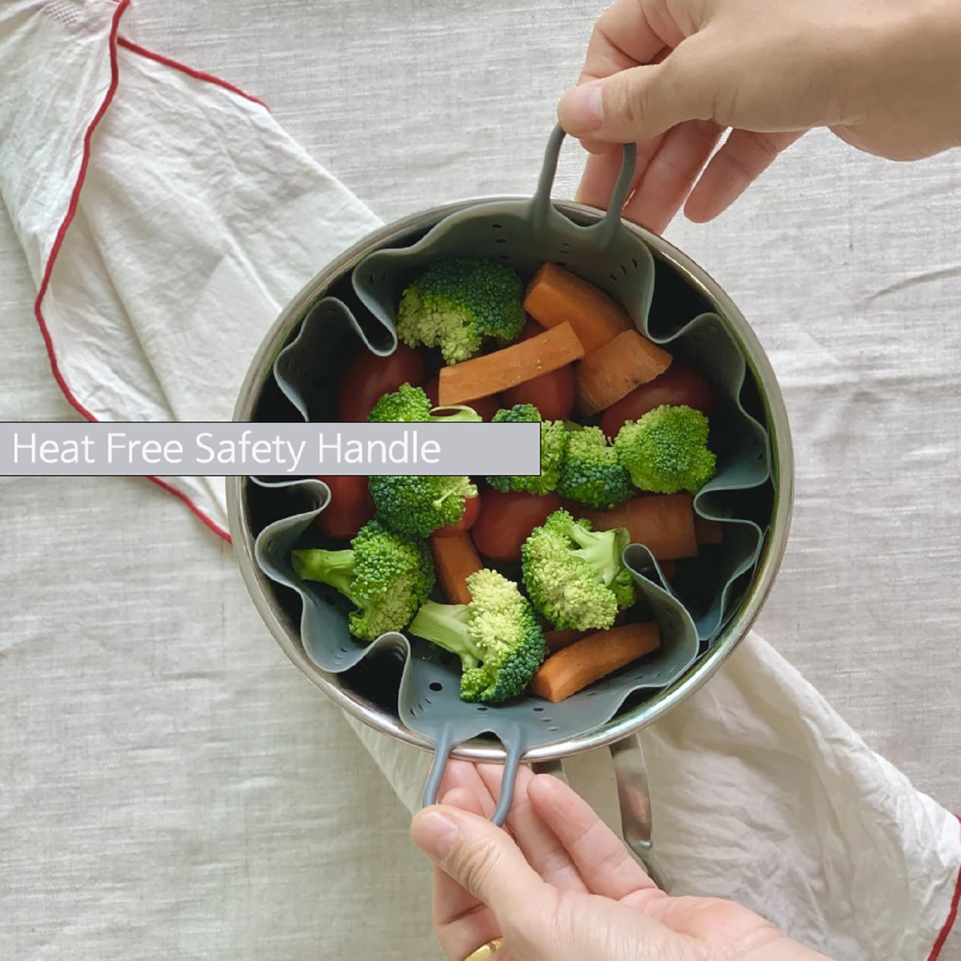Cozymomdeco grey silicone steamer in use for vegetables.