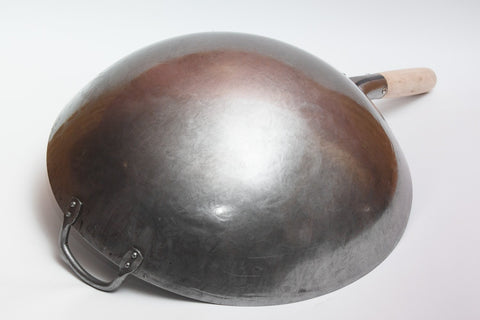 Steel helper handle remains cool during high-heat searing and quick tosses.