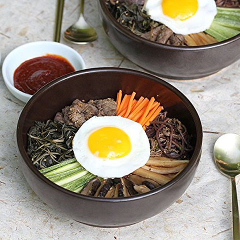 Crazy Korean Cooking Ceramic dolsot on stove shows versatile use for stews and bibimbap.