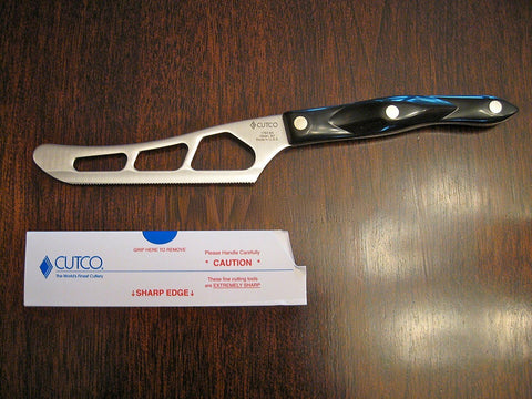 Cutco Model 1764 cheese knife showing perforations to prevent sticking on dense cheeses.
