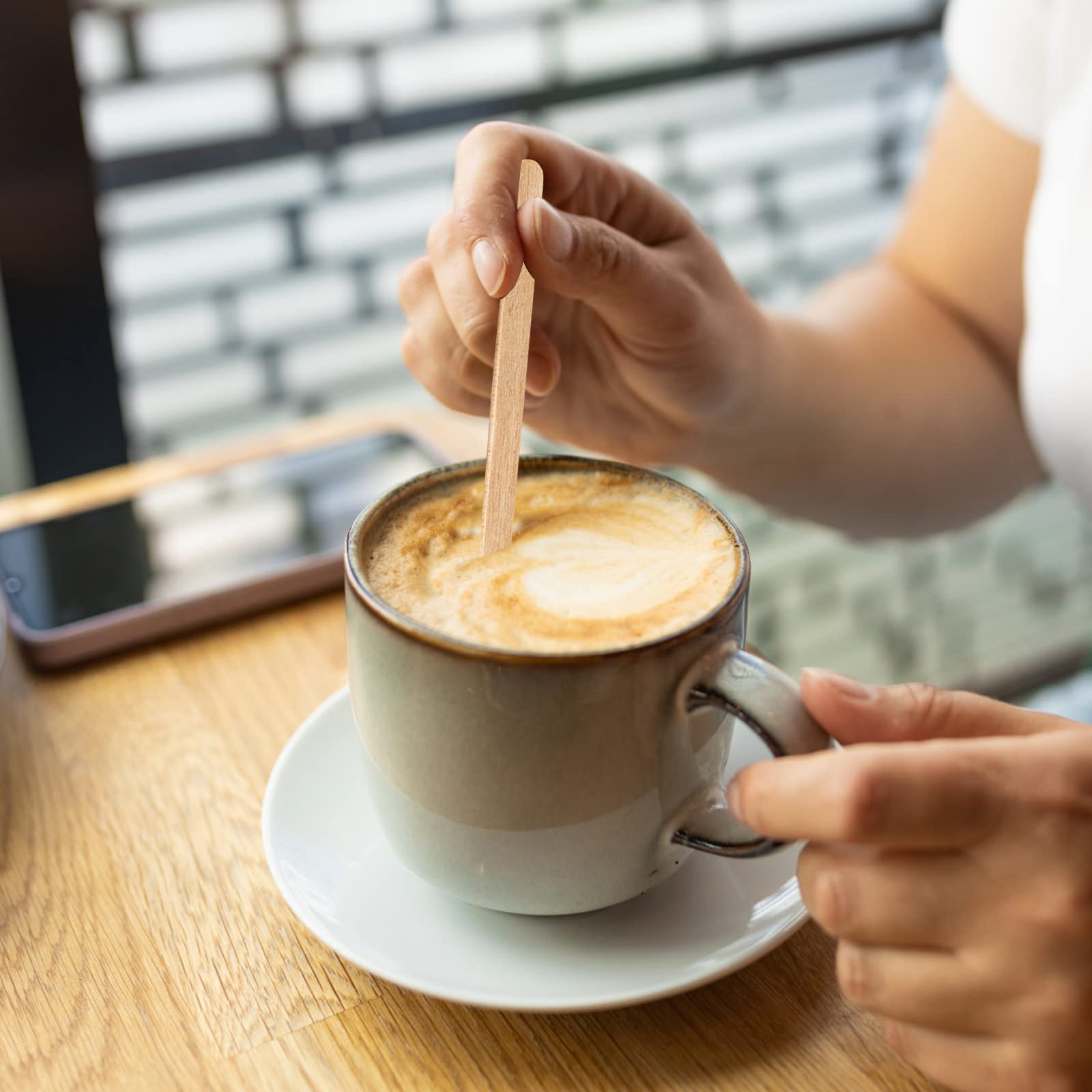 DEBECTY stir sticks shown in a beverage, illustrating versatile use.
