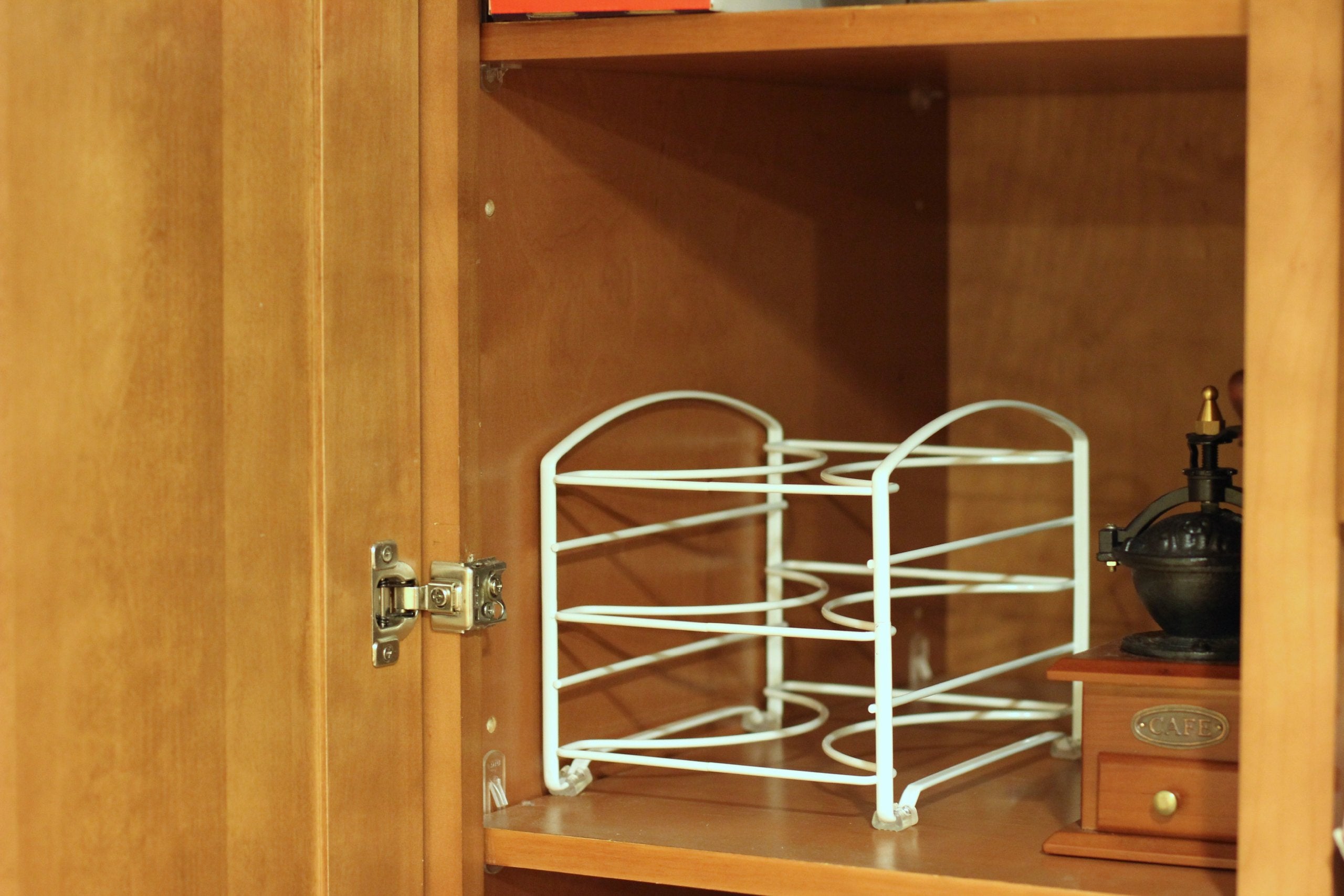 Compact wrap organizer fits three wraps per row in a shallow cabinet.