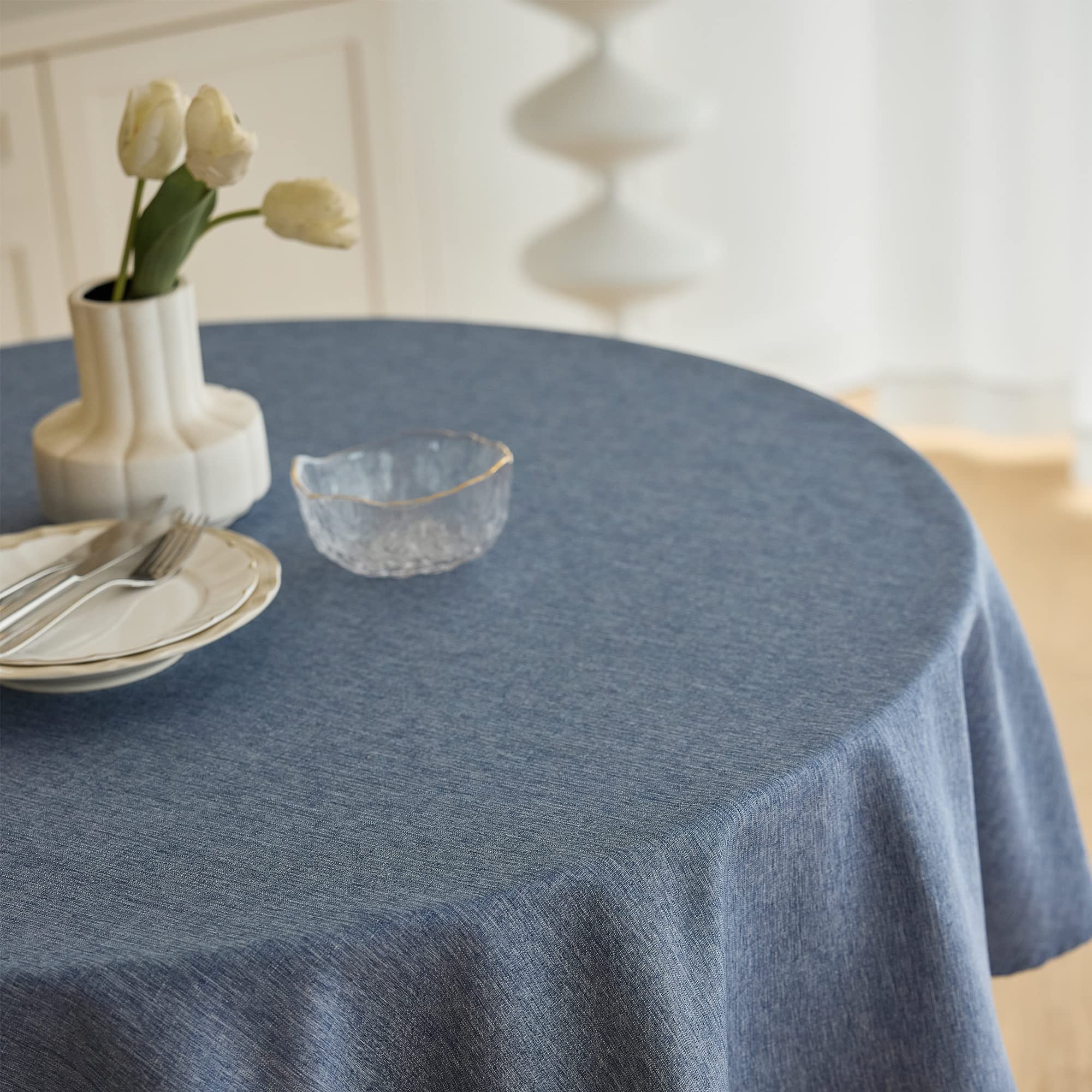 Close-up of Decorelia denim-blue tablecloth showing stain-repellent finish