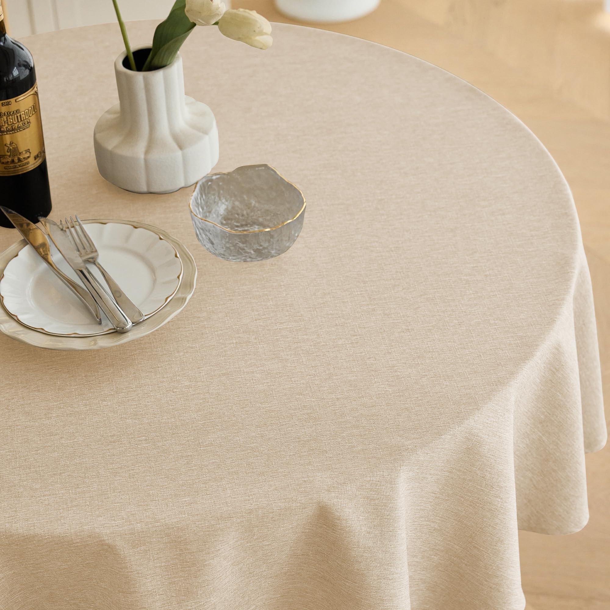 Beige Decorelia round tablecloth on dining setup showing stain-repellent protection