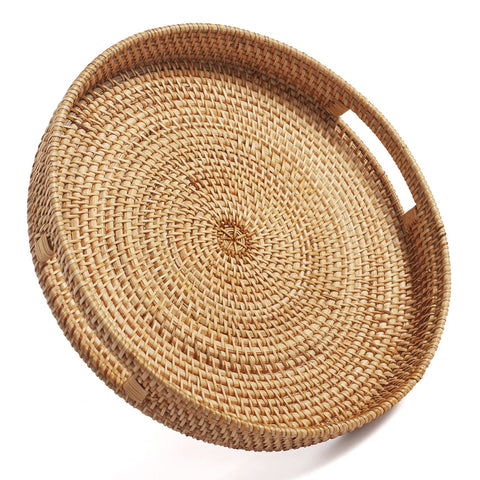 Decrafts round rattan tray with handles for easy serving.