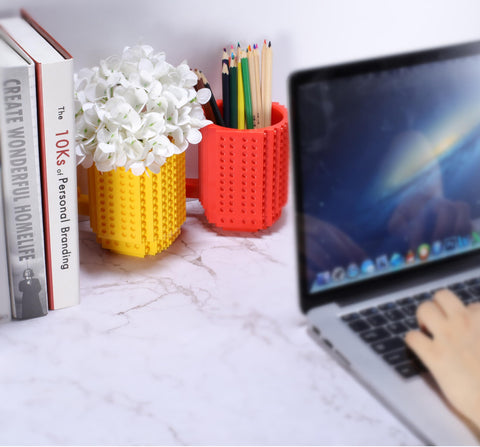 DEEXITO Build on Brick Mug serves as a small vase for desk accents.