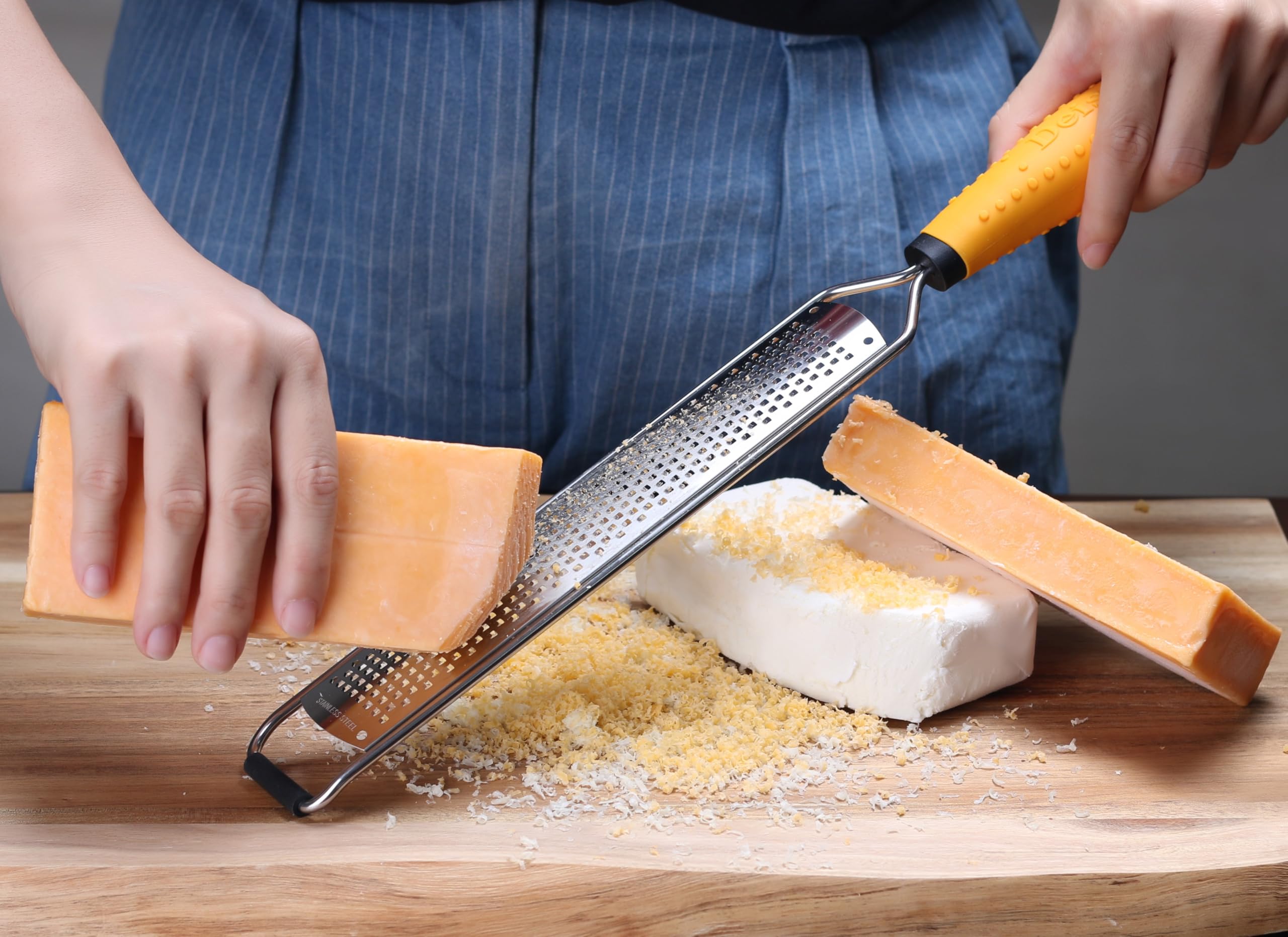 Deiss PRO zester grater processing garlic and ginger for fresh flavor.