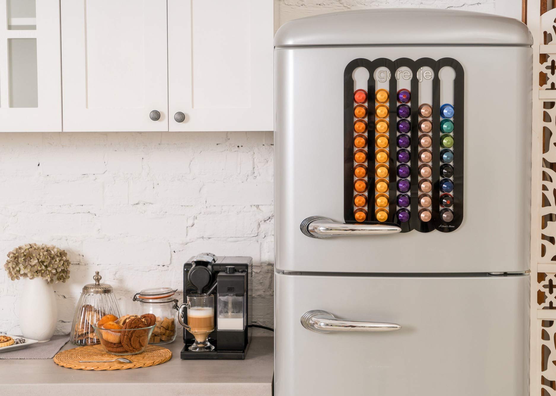 Strong magnets with anti-skid pads secure the holder on a clean fridge surface.