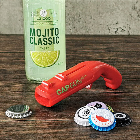 Dervyxious gun-shaped cap gun bottle opener featured in a themed event