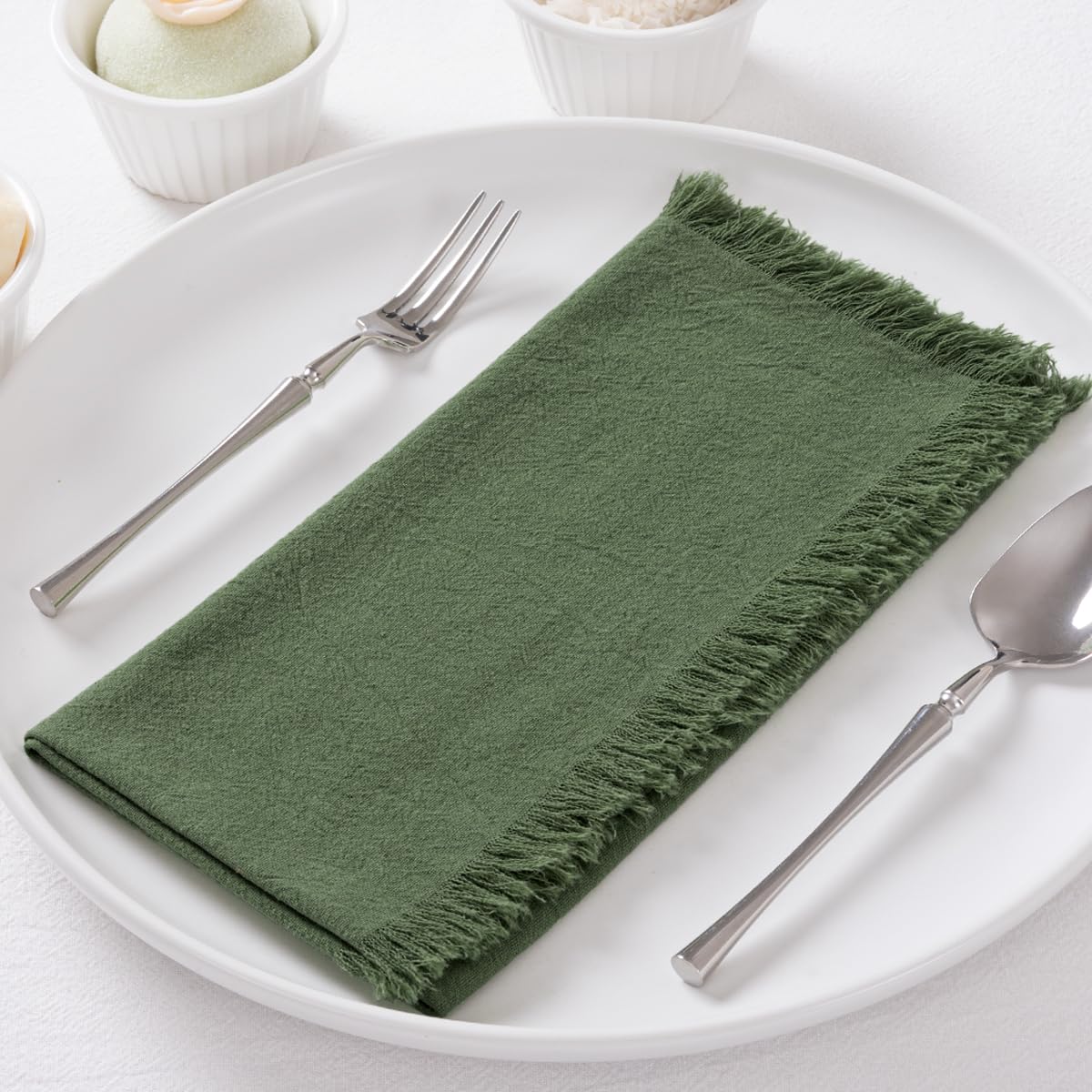 DeZerlor olive-green napkins with fringe edges add rustic charm and reusable elegance.