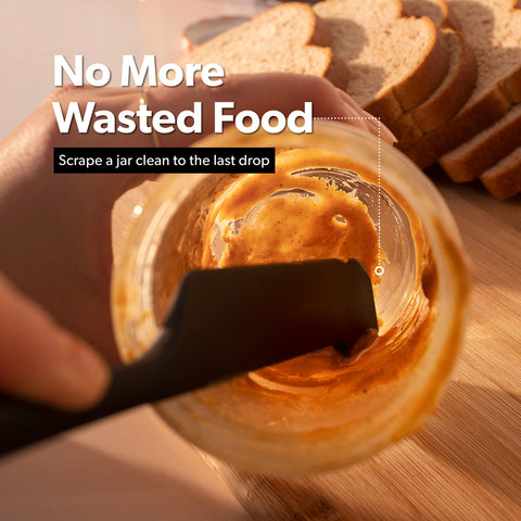 Di Oro Living silicone spatulas in a bowl, demonstrating effective scraping.