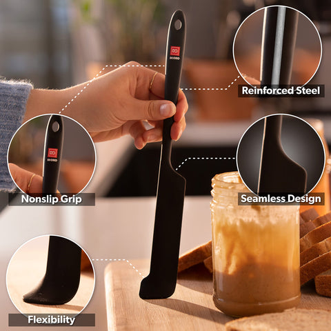Di Oro Living spatula near a hot pan, showcasing 600°F heat resistance.