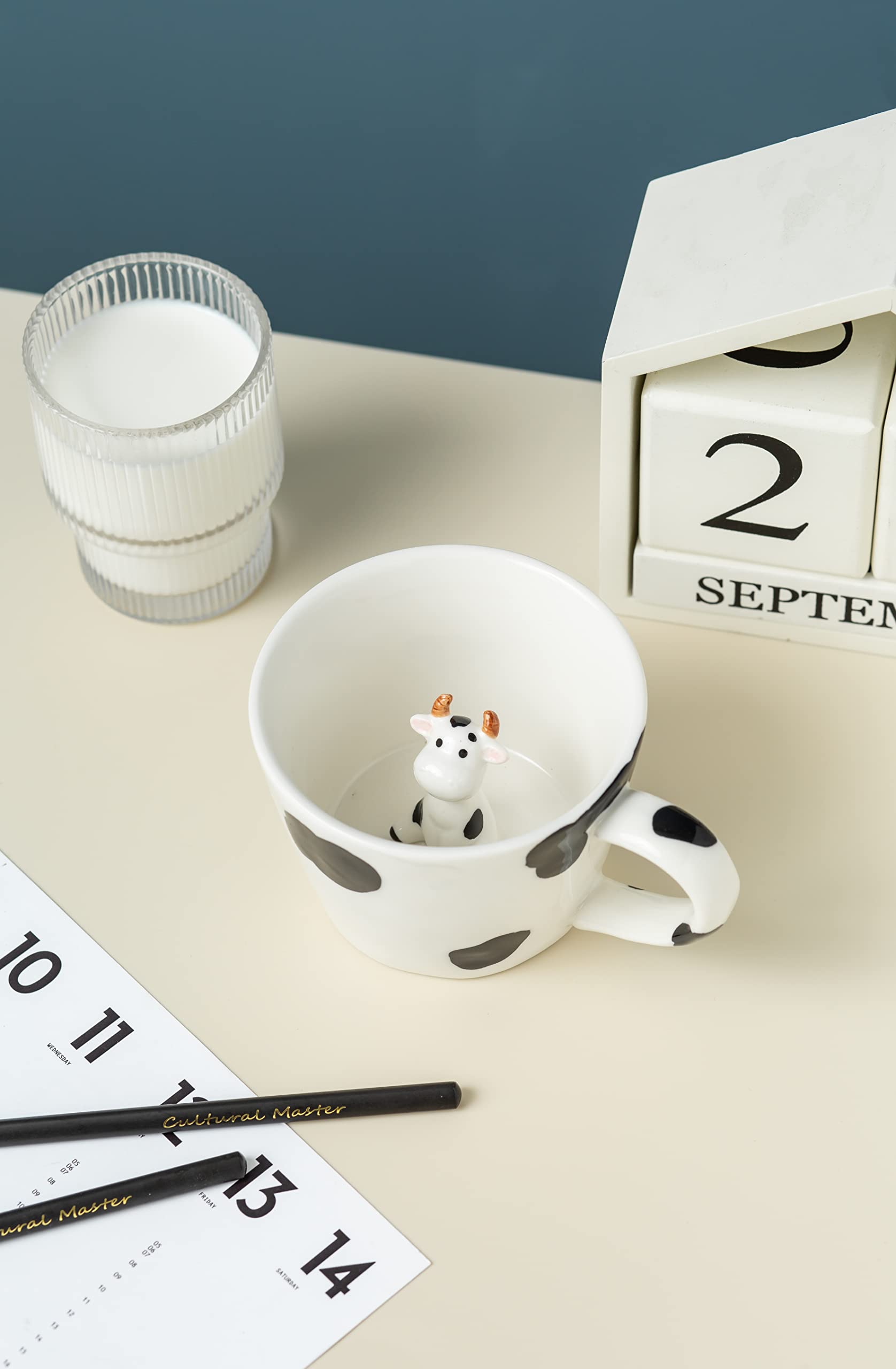 DIHOclub hand-painted mug features black and white cow design.
