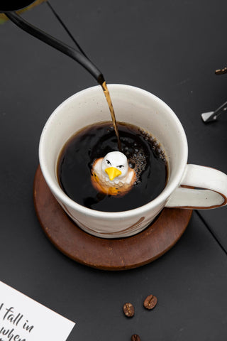 DIHOclub animal-figurine mug perched on rim adds whimsy.
