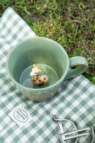 Green glazed DIHOclub giraffe mug highlighting whimsical wild-animal artwork