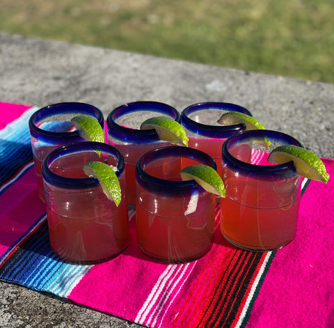 Dos Sueños 10 oz glass with cobalt rim for water or juice.