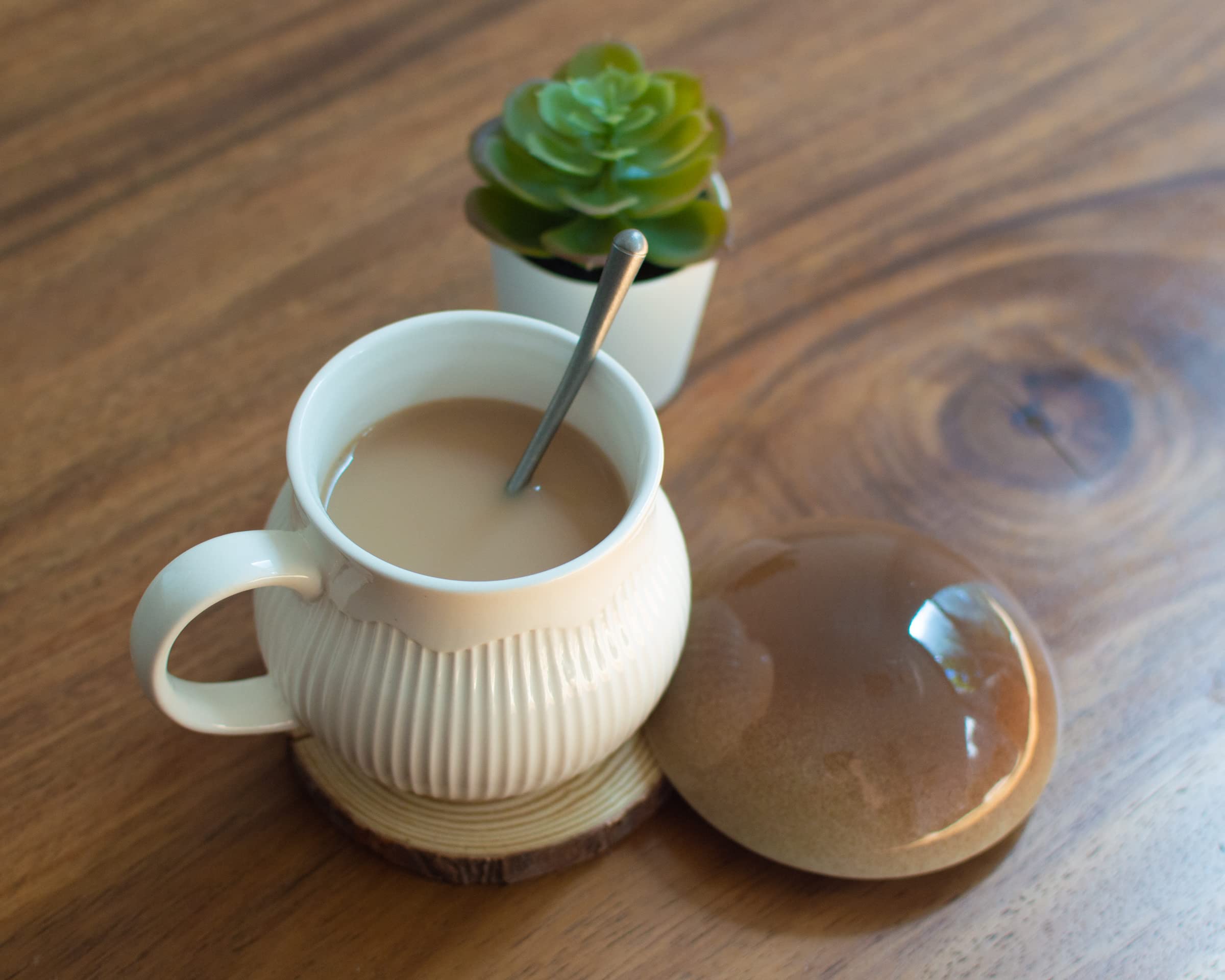 Dreamstall mushroom lid detail on stoneware mug for spill-free sipping.