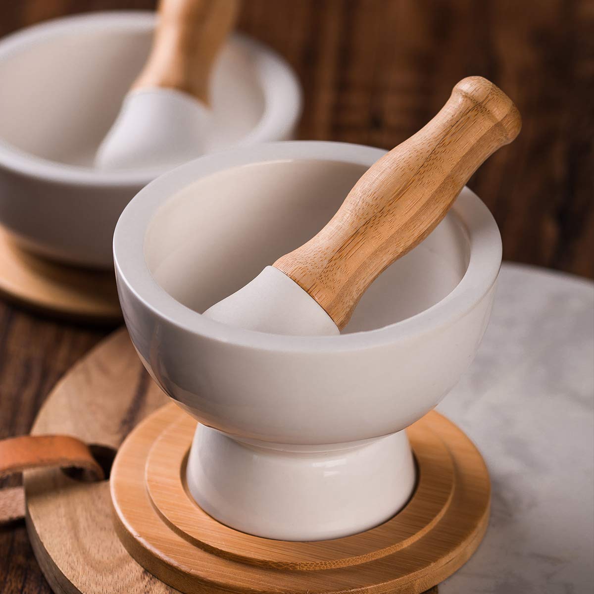 Sustainable bamboo accents on pestle handle and coaster.