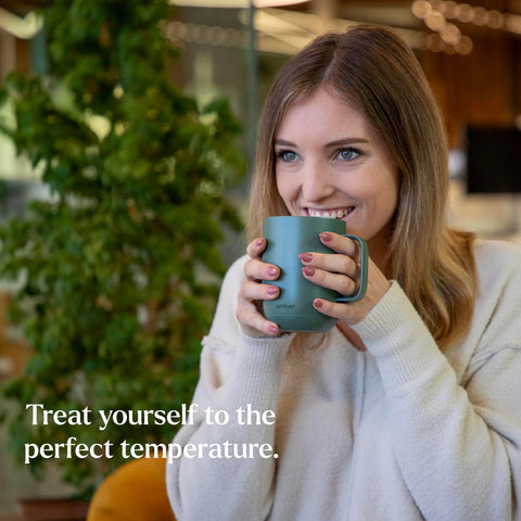 Ember Mug 2 sage green on-desk use showing portable warmth