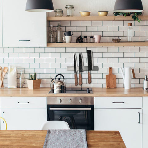 Enkrio wall-mounted magnetic strip keeps countertops tidy and organized.