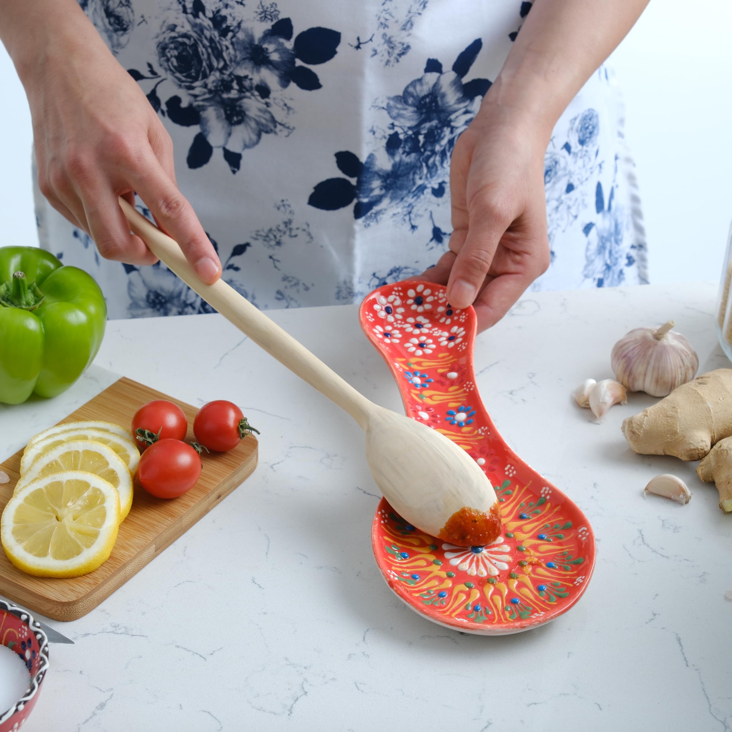 EVANILIFE orange spoon rest on kitchen counter with spatula.